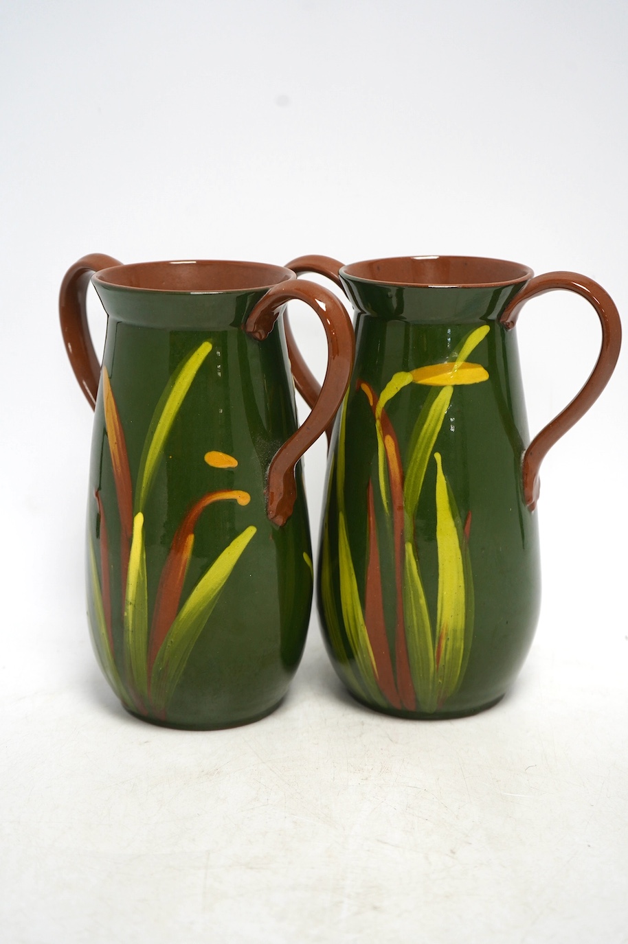 A pair of Watcombe Torquay vases decorated with daffodils, 20cm high. Condition - good